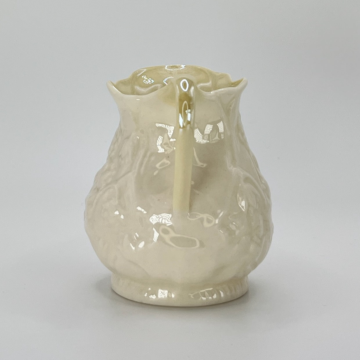 Belleek Cream Pitcher – Irish Parian Porcelain with Embossed Florals & Yellow Handle (6th Mark, 1965–1980)