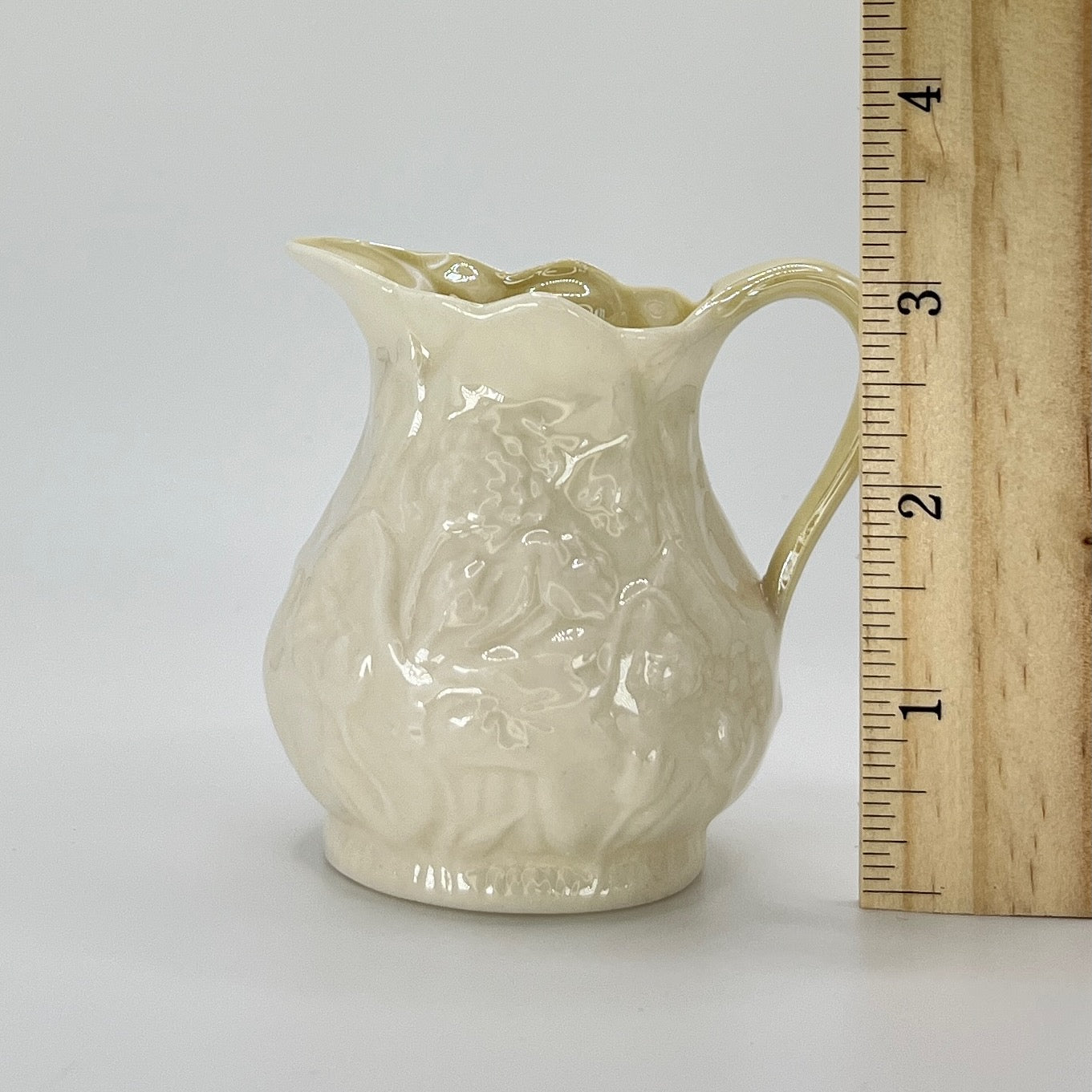 Belleek Cream Pitcher – Irish Parian Porcelain with Embossed Florals & Yellow Handle (6th Mark, 1965–1980)
