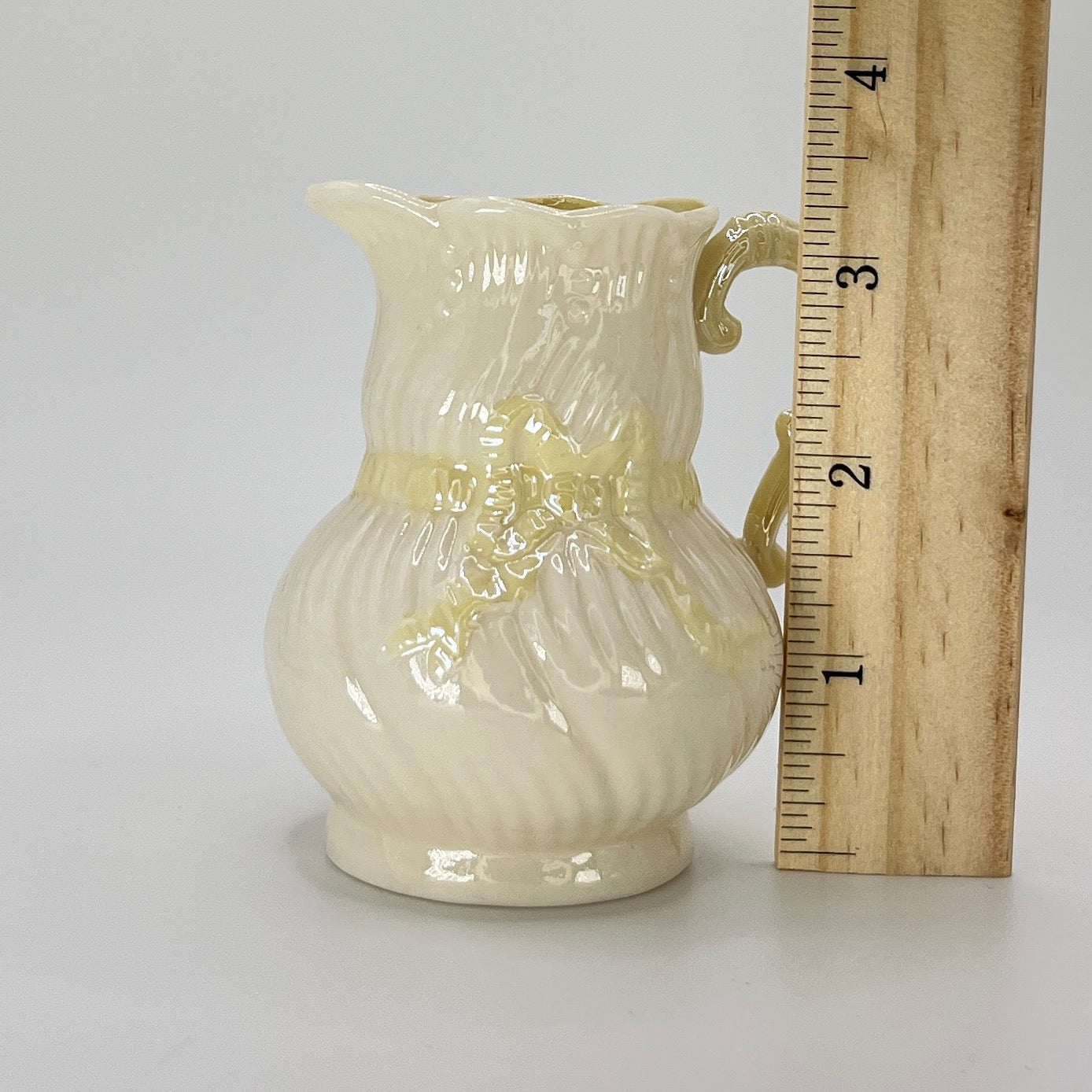 Belleek Cream Pitcher with Embossed Bow & Gold Handle – Ireland, 6th Mark (1965–1980)