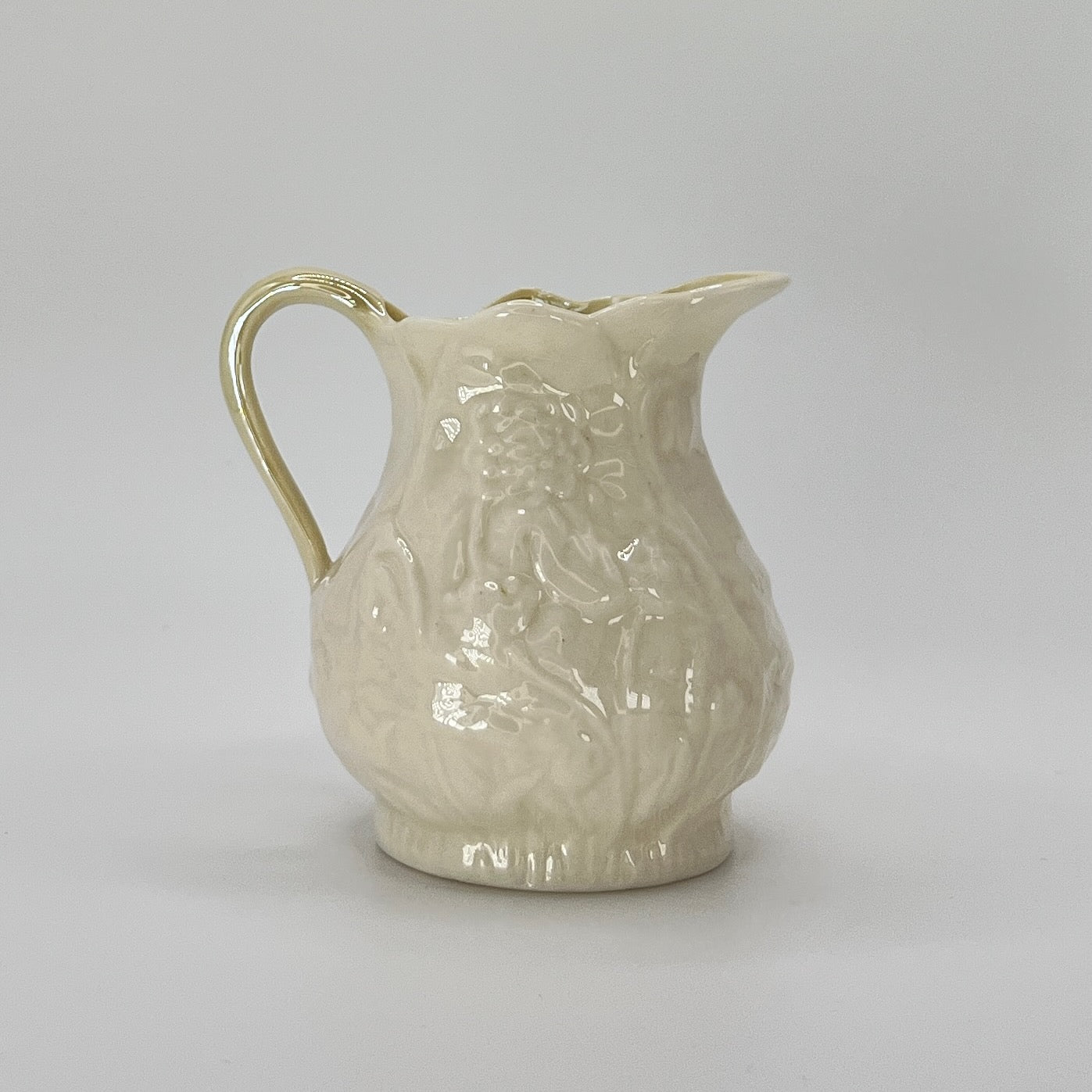 Belleek Cream Pitcher – Irish Parian Porcelain with Embossed Florals & Yellow Handle (6th Mark, 1965–1980)