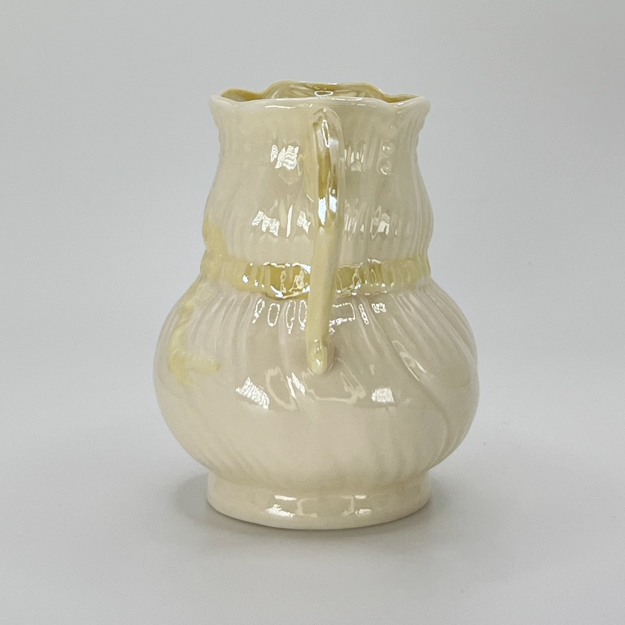 Belleek Cream Pitcher with Embossed Bow & Gold Handle – Ireland, 6th Mark (1965–1980)